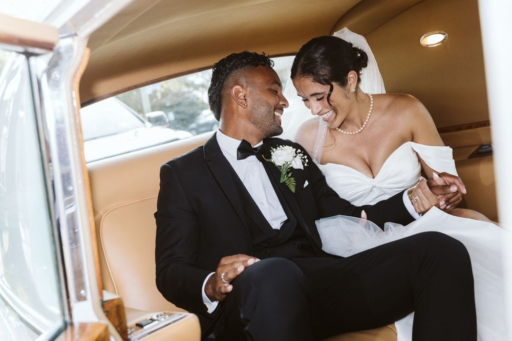 Couples dance together during a wedding reception in an elegant indoor venue with warm lighting.