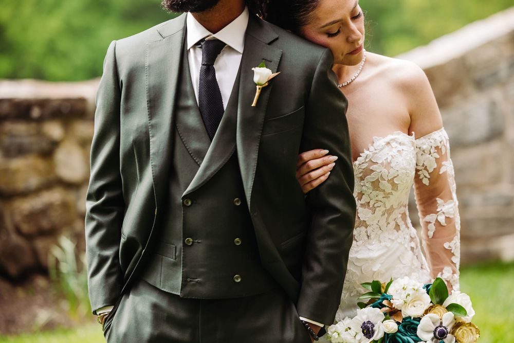 Romantic garden setting with lush greenery and elegant formal attire.