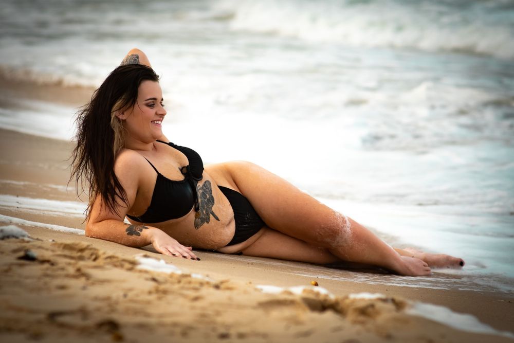 Beachside photography with waves and sandy shoreline.