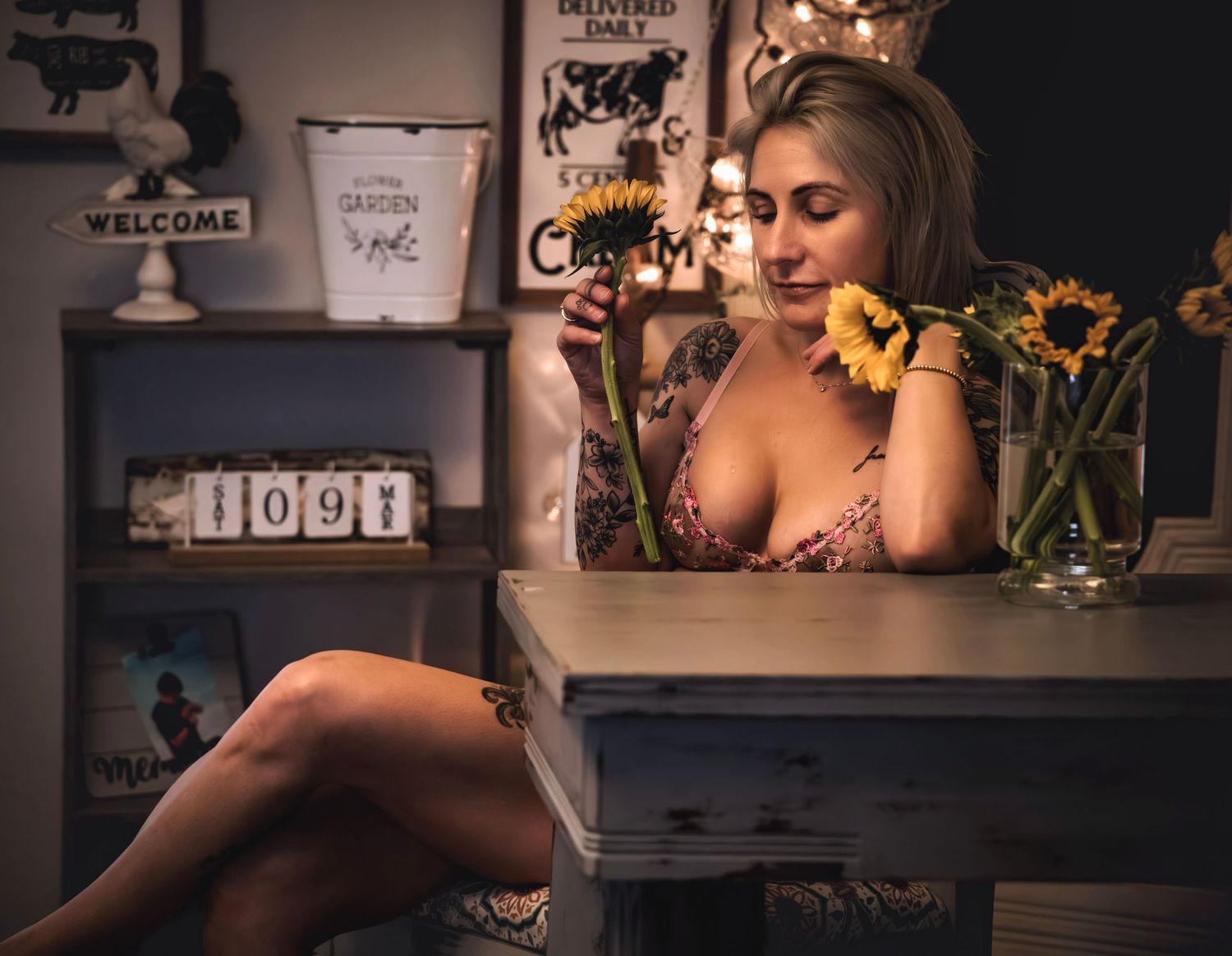 Artistic photo shoot with rustic farmhouse decor and sunflowers in warm lighting.