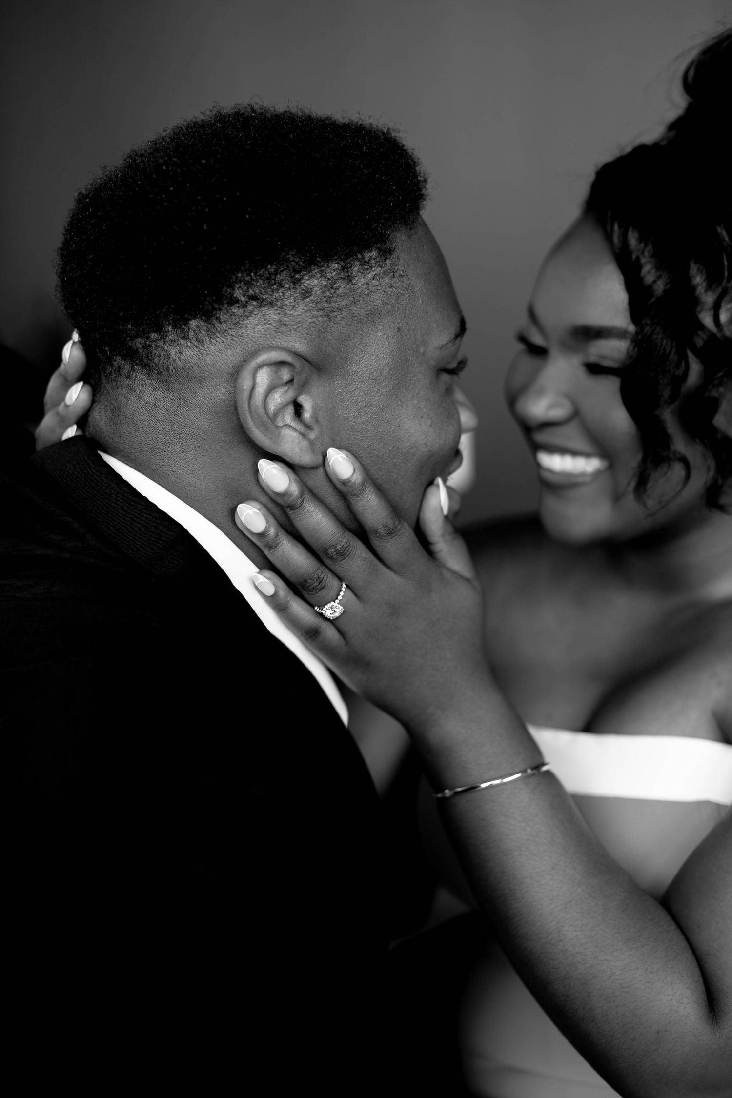 Black and white portrait of couple sharing tender moment.