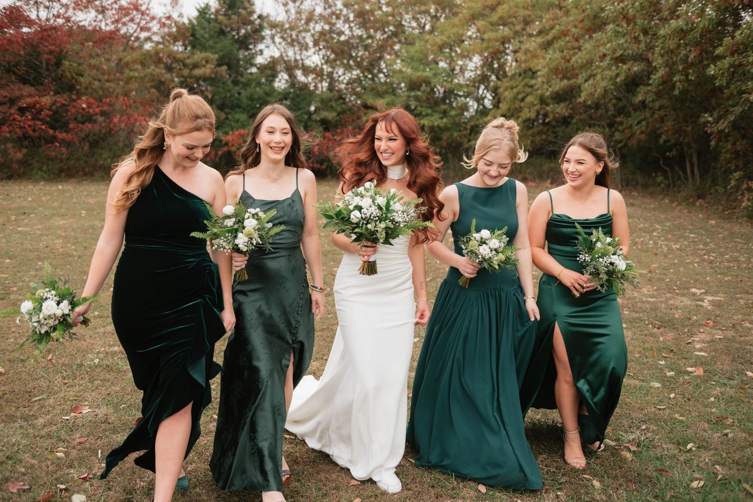Romantic wedding couple embraces on a lush green lawn during golden hour.