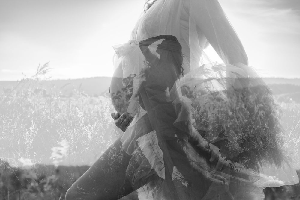 Ethereal black and white portrait of figure in flowing dress.