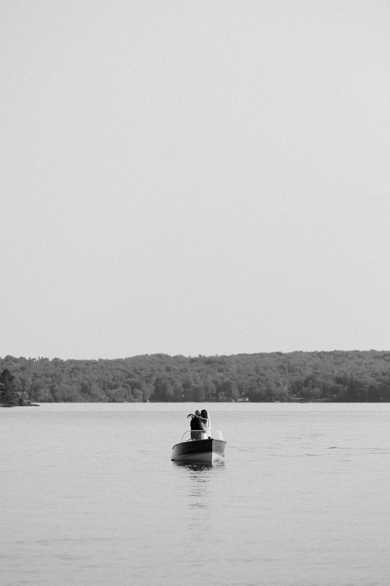 Newlywed couple portrait on a boat during a Muskoka wedding, photographed by Claudia Emma Photography