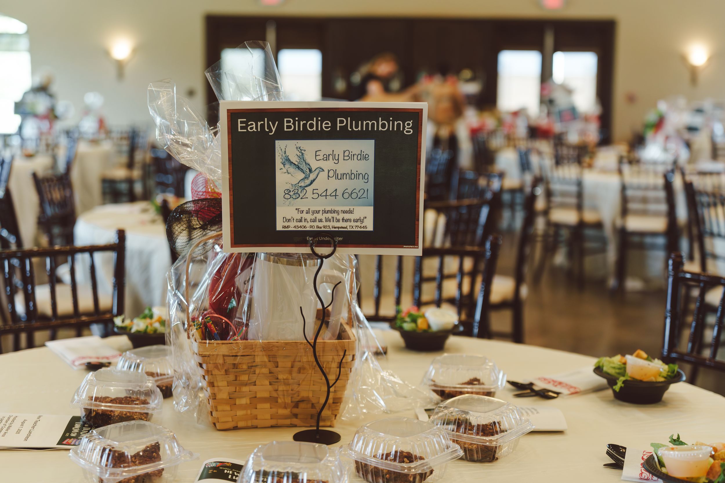 Wedding reception table settings with rustic decor, wooden signs, and glowing candles in an elegant dining room.
