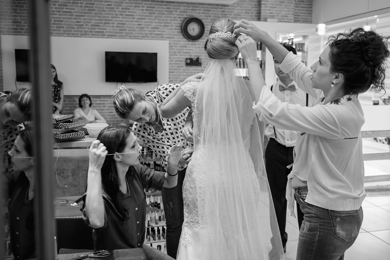 A wedding dress being fitted and adjusted in a bridal salon.