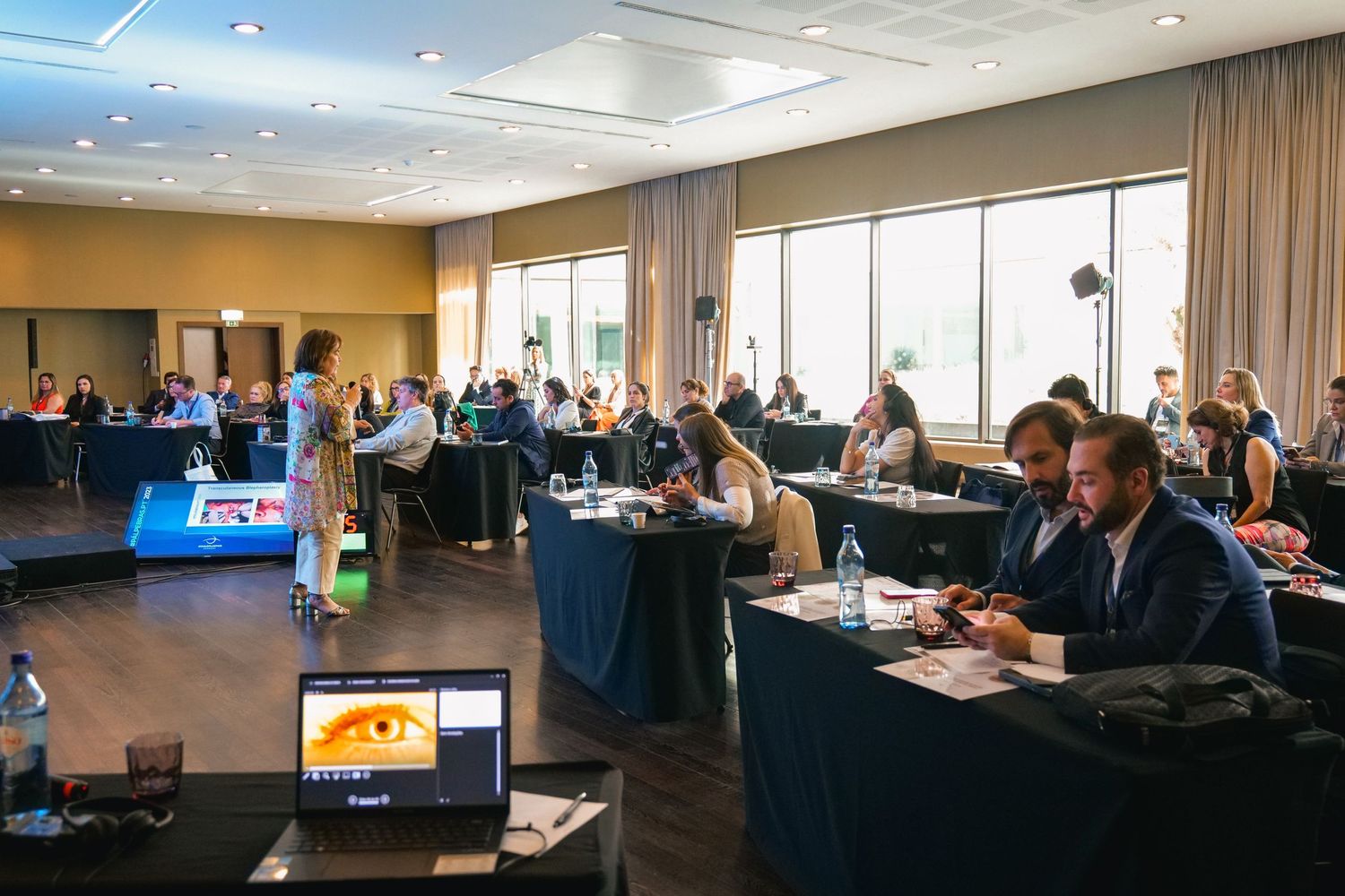 Medical professionals attending a conference workshop session in a modern well-lit conference room.