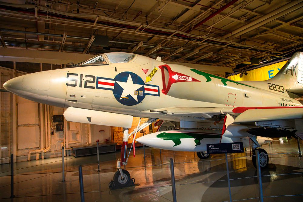 Classic A-4 Skyhawk fighter plane with US military markings displayed in museum.