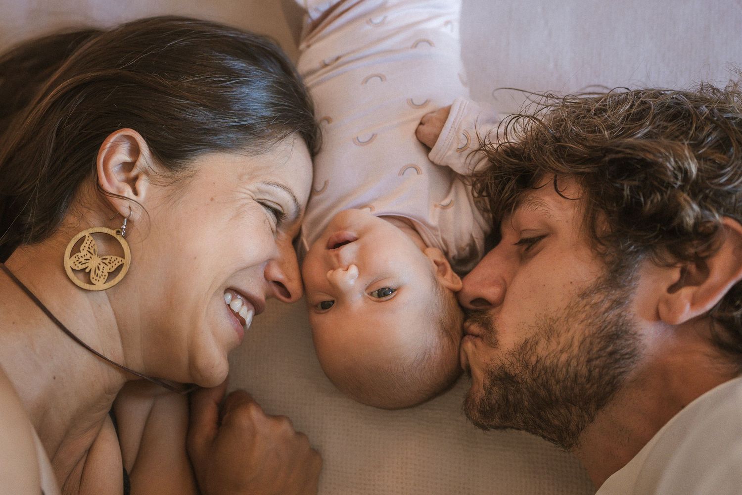 Intimate family portrait showing tender moment with baby.