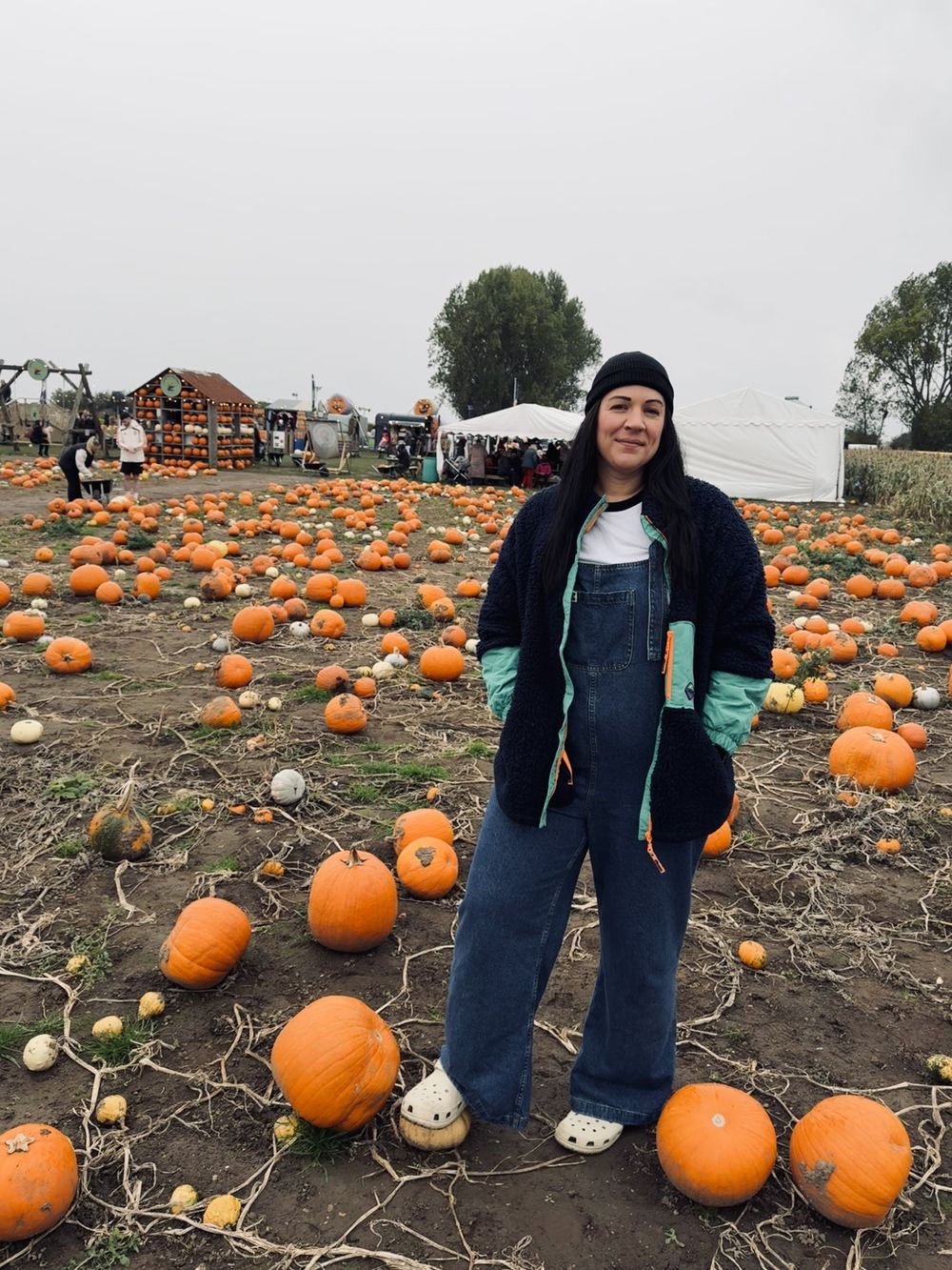 Photos of someone bundled up in winter clothing exploring a pumpkin patch on an overcast autumn day. Photographer. Hull. East Yorkshire.