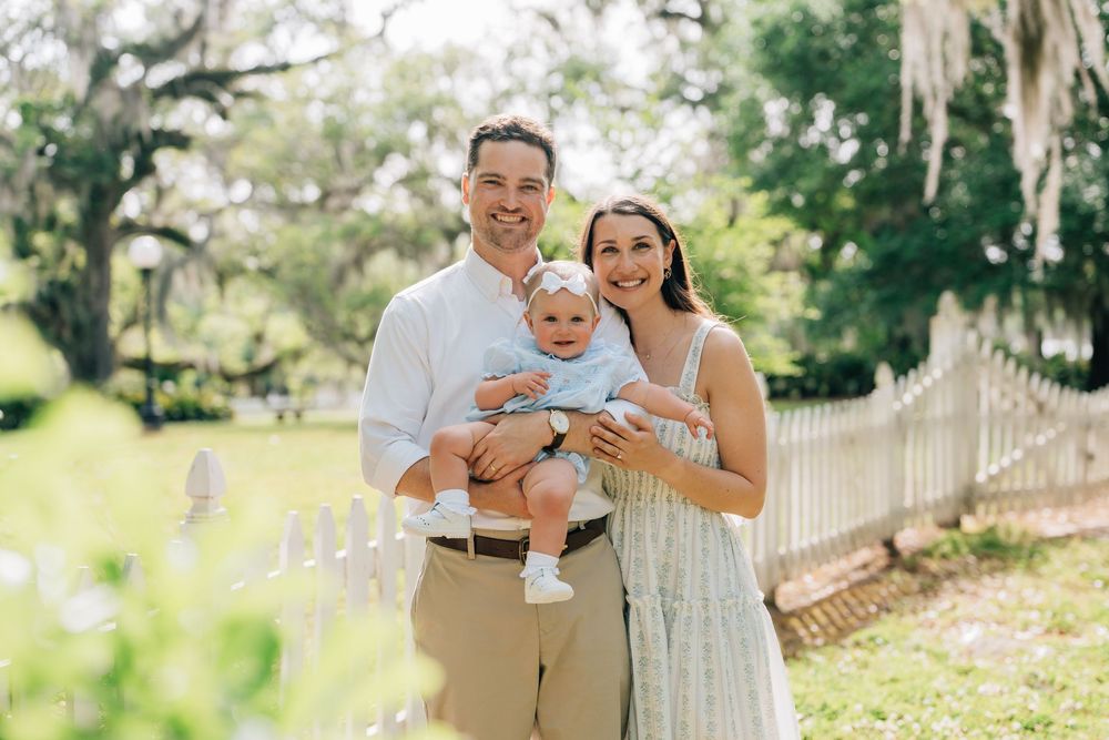 A mom, dad and baby smile at Fairview Riverside State Park