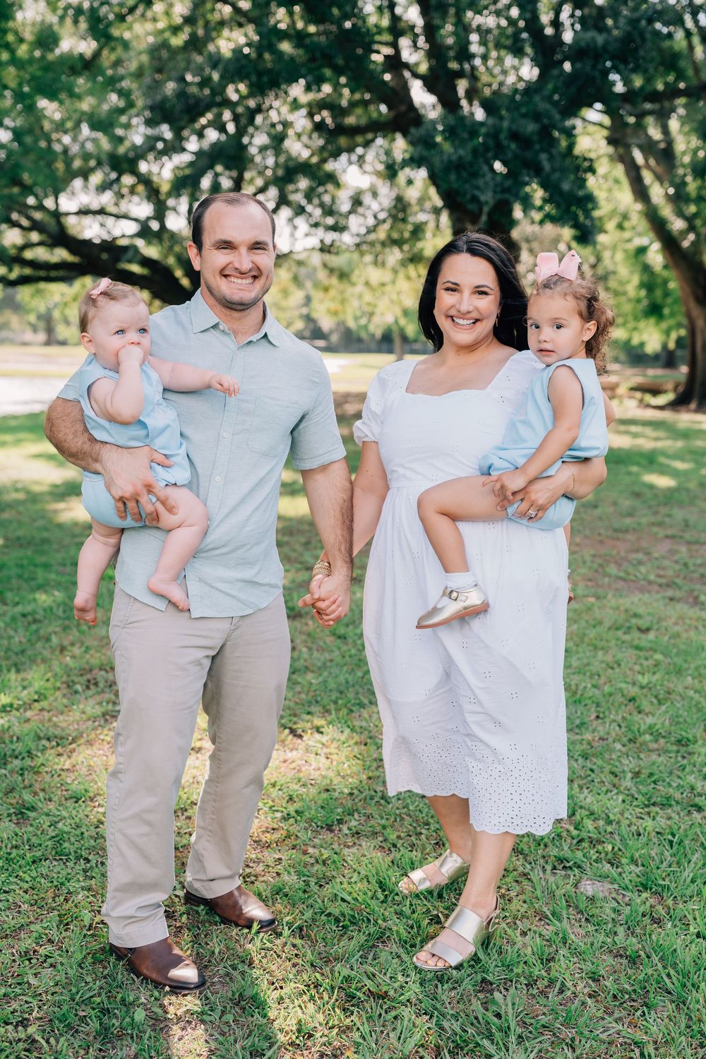 A family smiling in Jesuit Bend Park in Belle Chasse, LA
