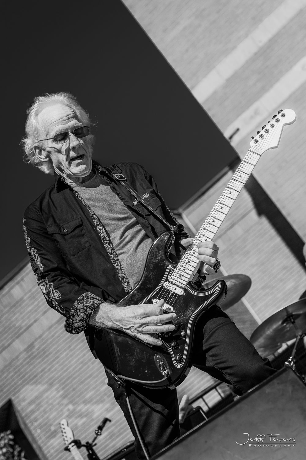 Rock Guitar Player on outdoor stage.