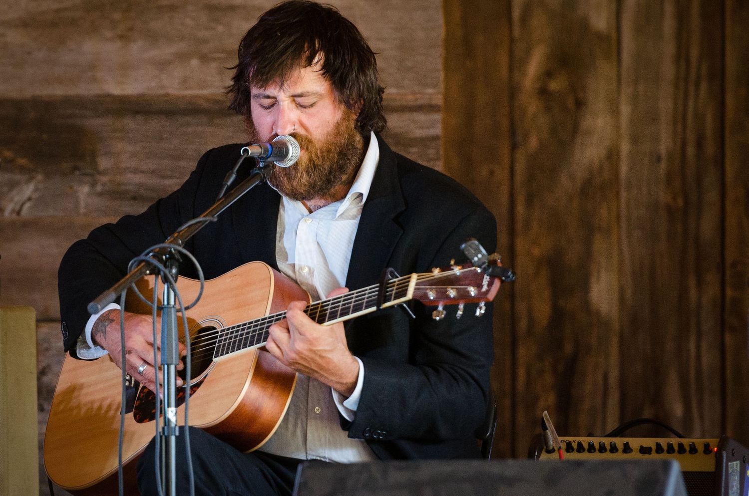 Folk singer playing acoustic guitar.