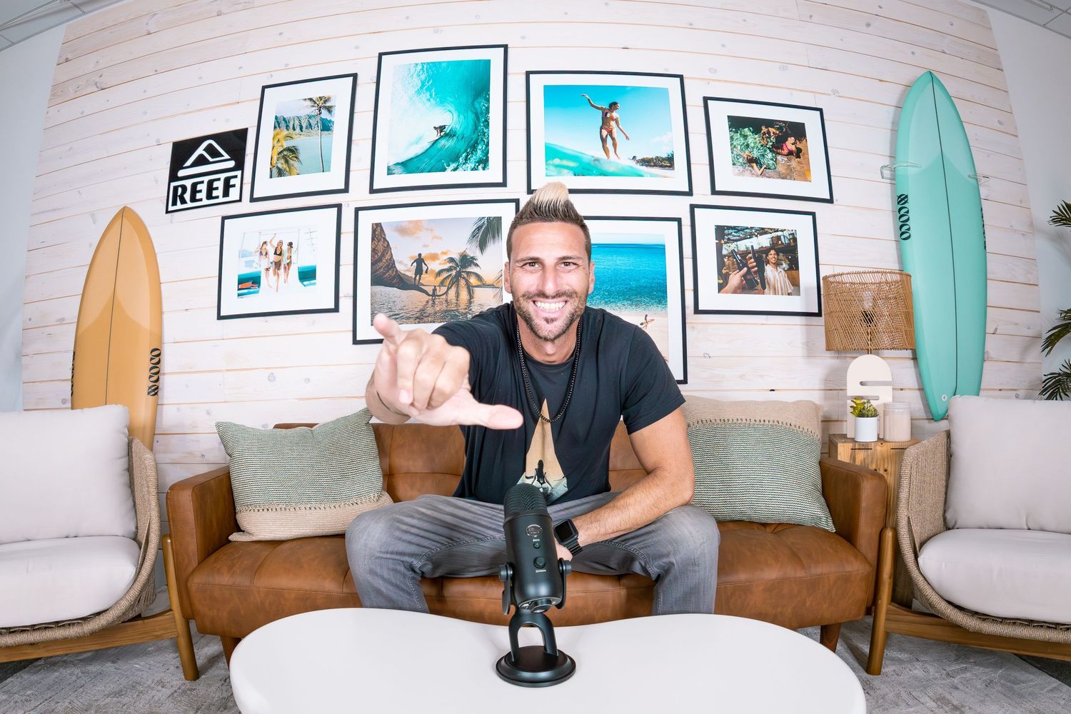 Profile photo of San Diego surf photographer Steve in a studio with surfboards, framed prints, and a microphone.
