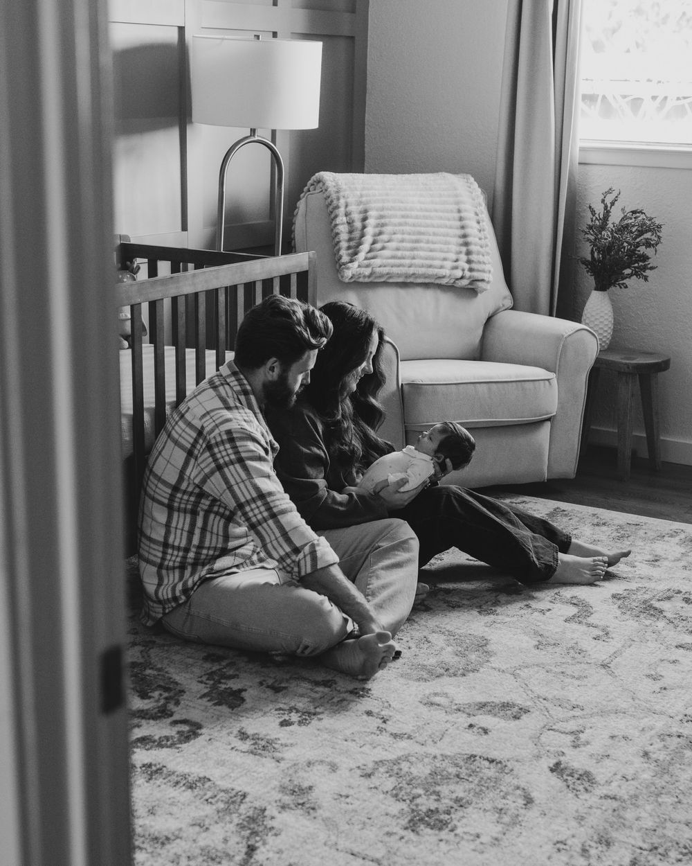 Black and white vintage image showing adults engaged in a therapeutic session sitting on a carpeted floor.