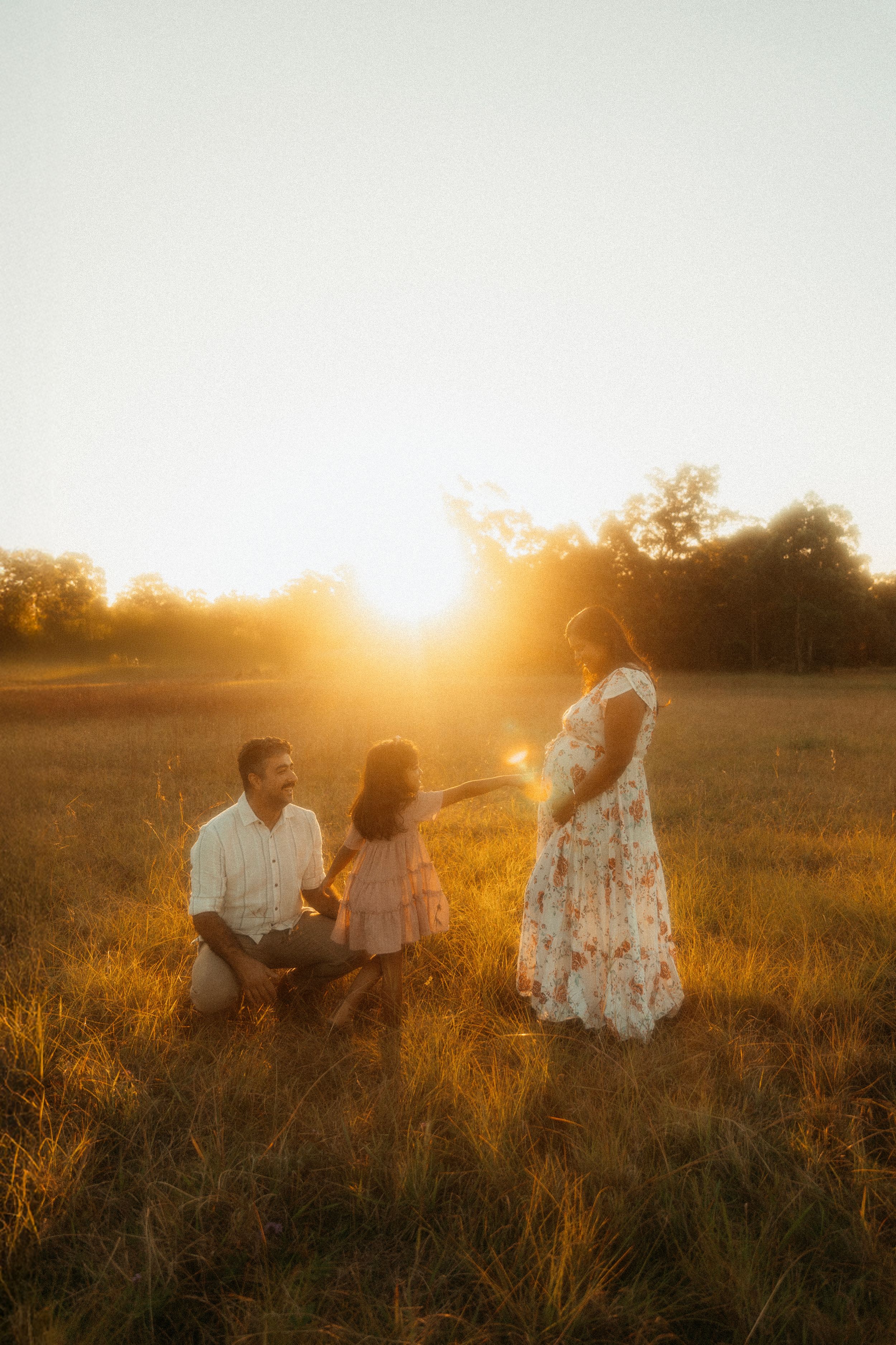 Intimate family moment captured in warm sunset light.