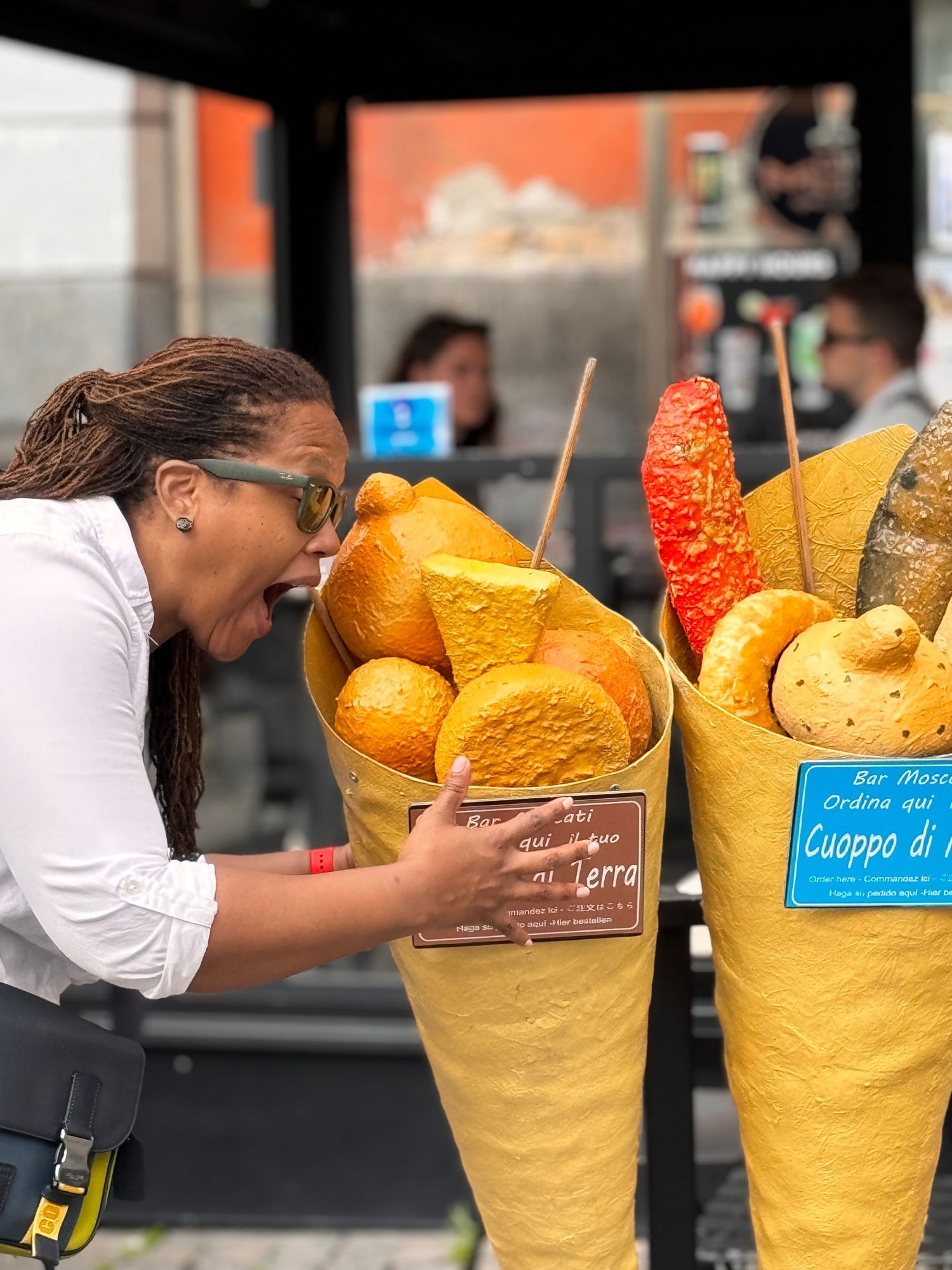 Jasmine taking a bite out of fake bread in Italy