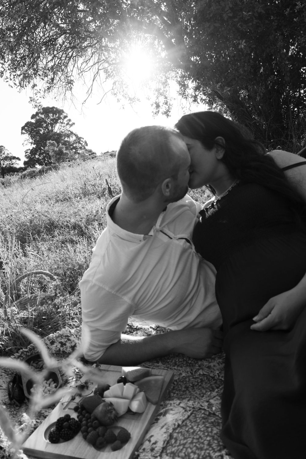 Black and white intimate couple's photoshoot in a meadow.