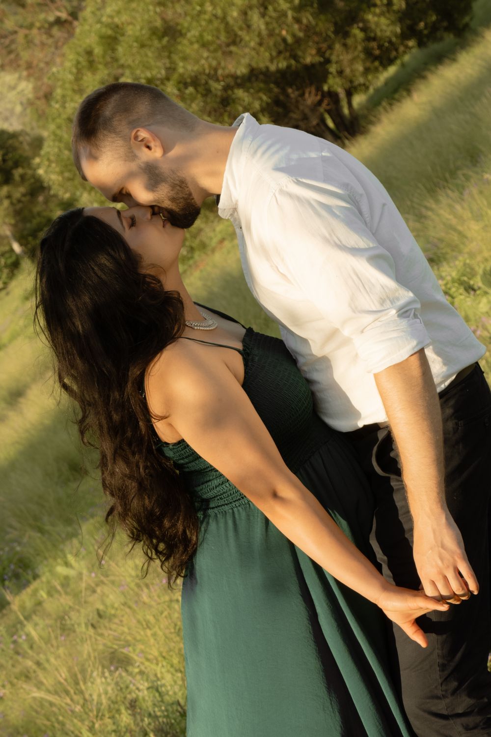 Intimate couple's portrait session in sunny field with golden light.