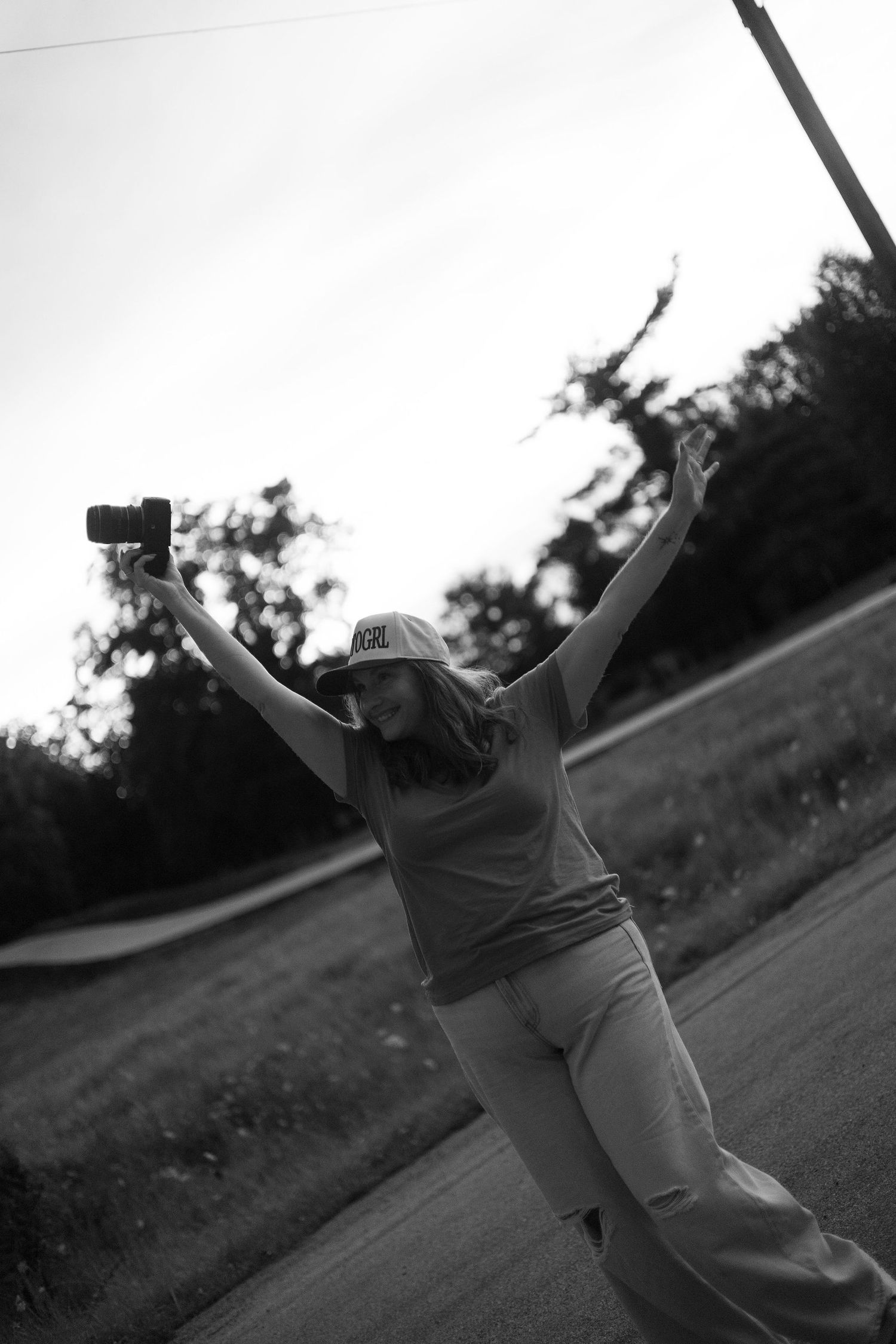 Nichole Sieck, a Cedar Rapids and Marion photographer, dances at sunset on a paved road.
