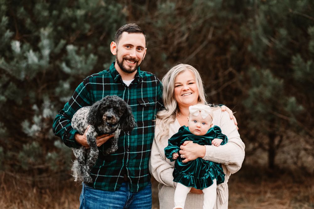 Family Christmas session outdoors near the Christmas trees in Davison Michigan. Including their dog