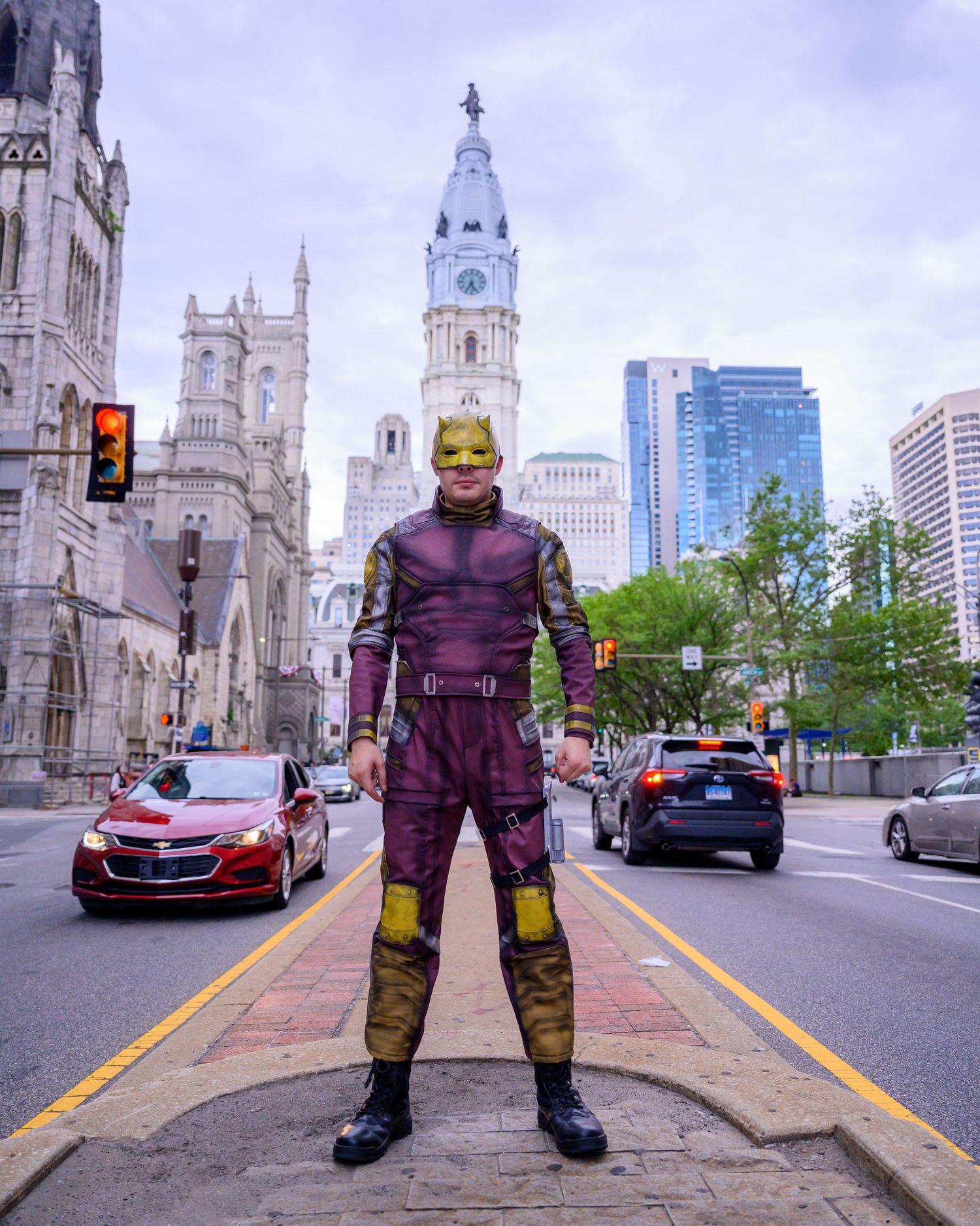 Four sequential photos showing a costumed figure posing in front of Philadelphia City Hall with the skyline in background.