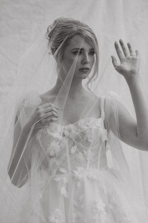 A dreamy black and white portrait series showing ethereal movements through delicate white fabric and veils.
