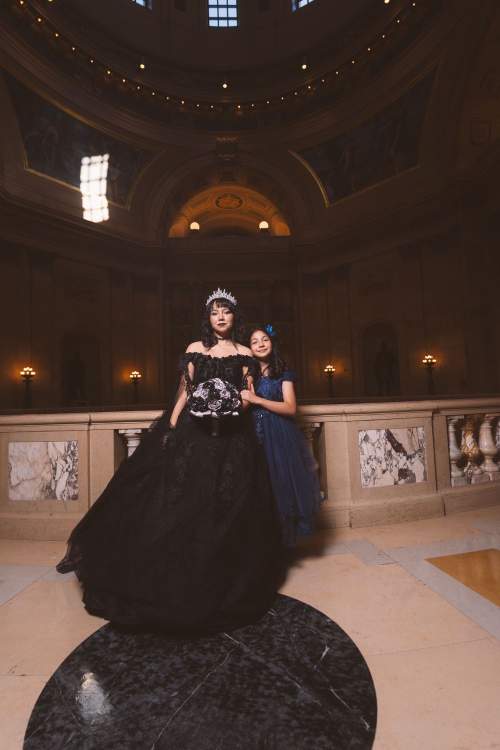 Artistic portrait session in a grand ballroom featuring classical architectural details.