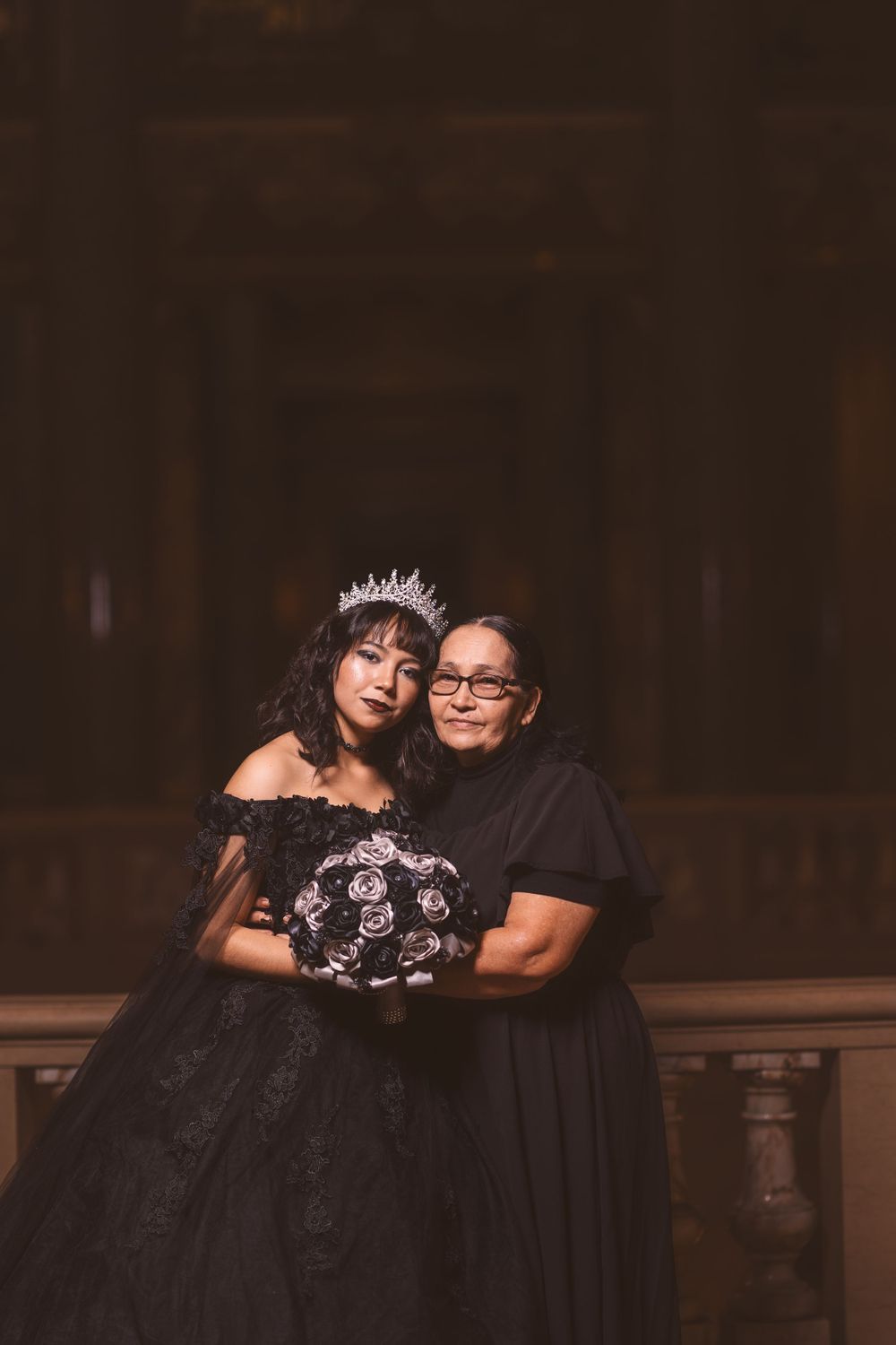 Intimate portrait session featuring formal attire in a dimly lit historic venue.