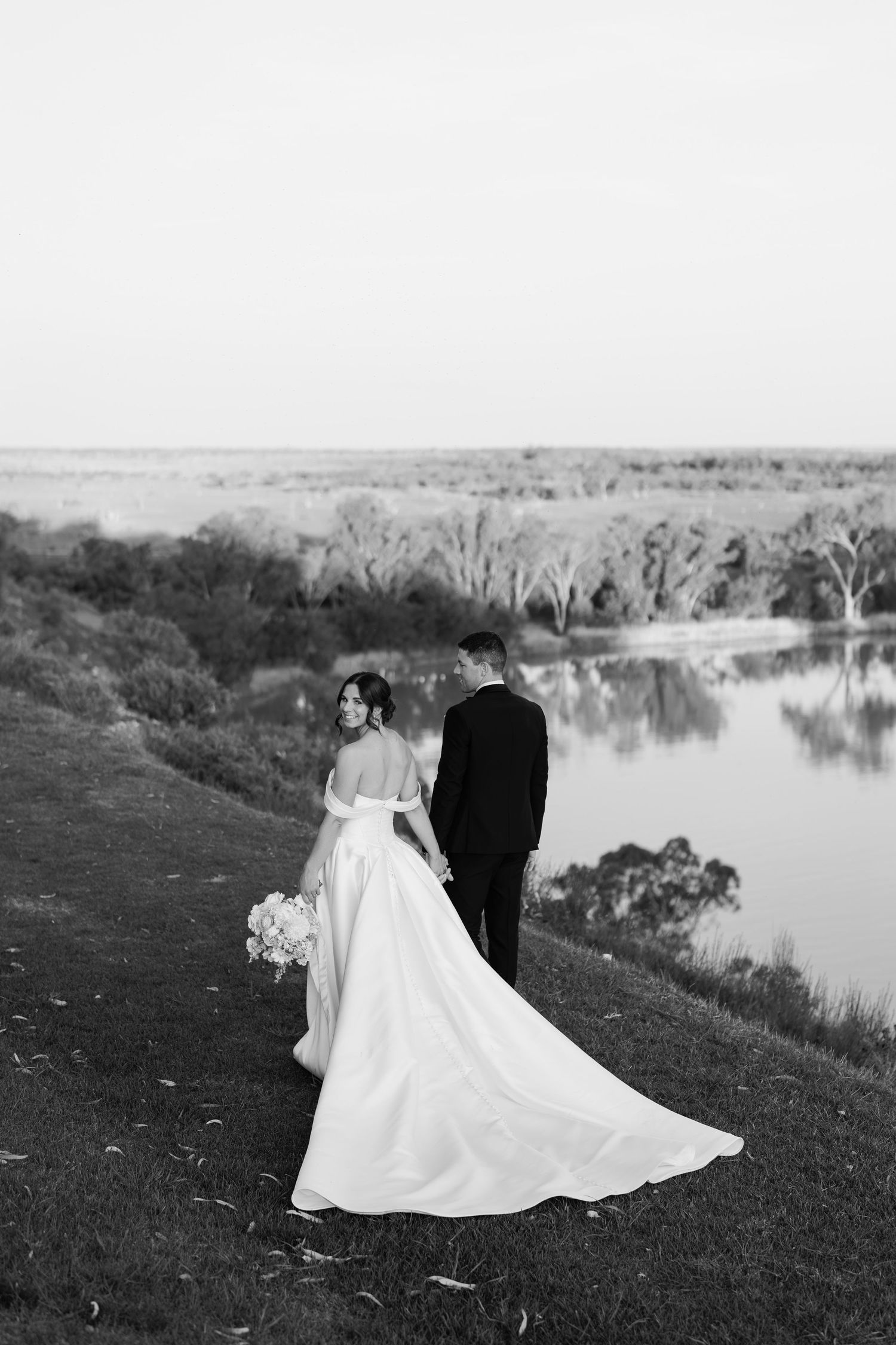 Bride and groom walking together at River Vista wedding in South Australia, surrounded by open views and soft natural light
