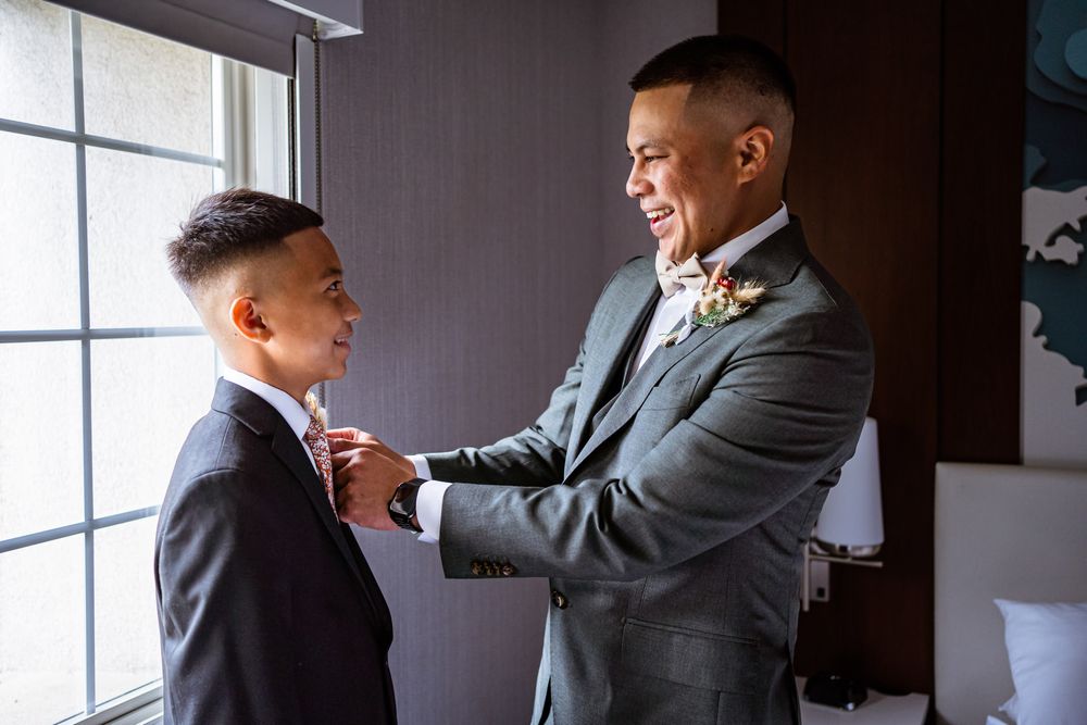 groom getting his son ready during his wedding day
