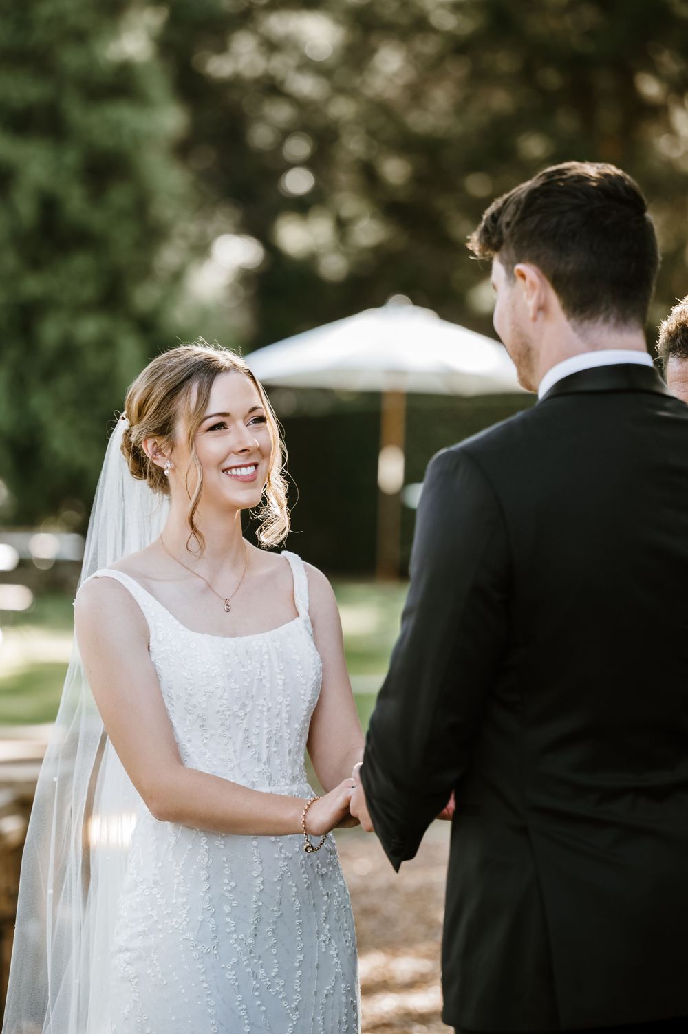 Joyful moment between couple during outdoor wedding ceremony.