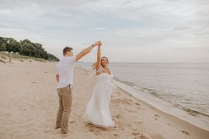 Romantic beach dance sequence with waves and cloudy sky.