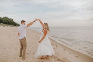 Couple performing romantic dance sequence by the ocean.