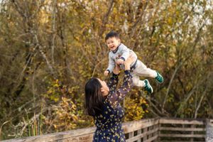 Mother throwing son up in the air at Juanita Bay Park.