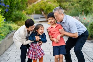 Grandparents tickling grandchildren in Seattle.
