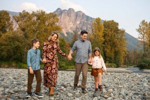 Family holding hands and walking at Three Forks.