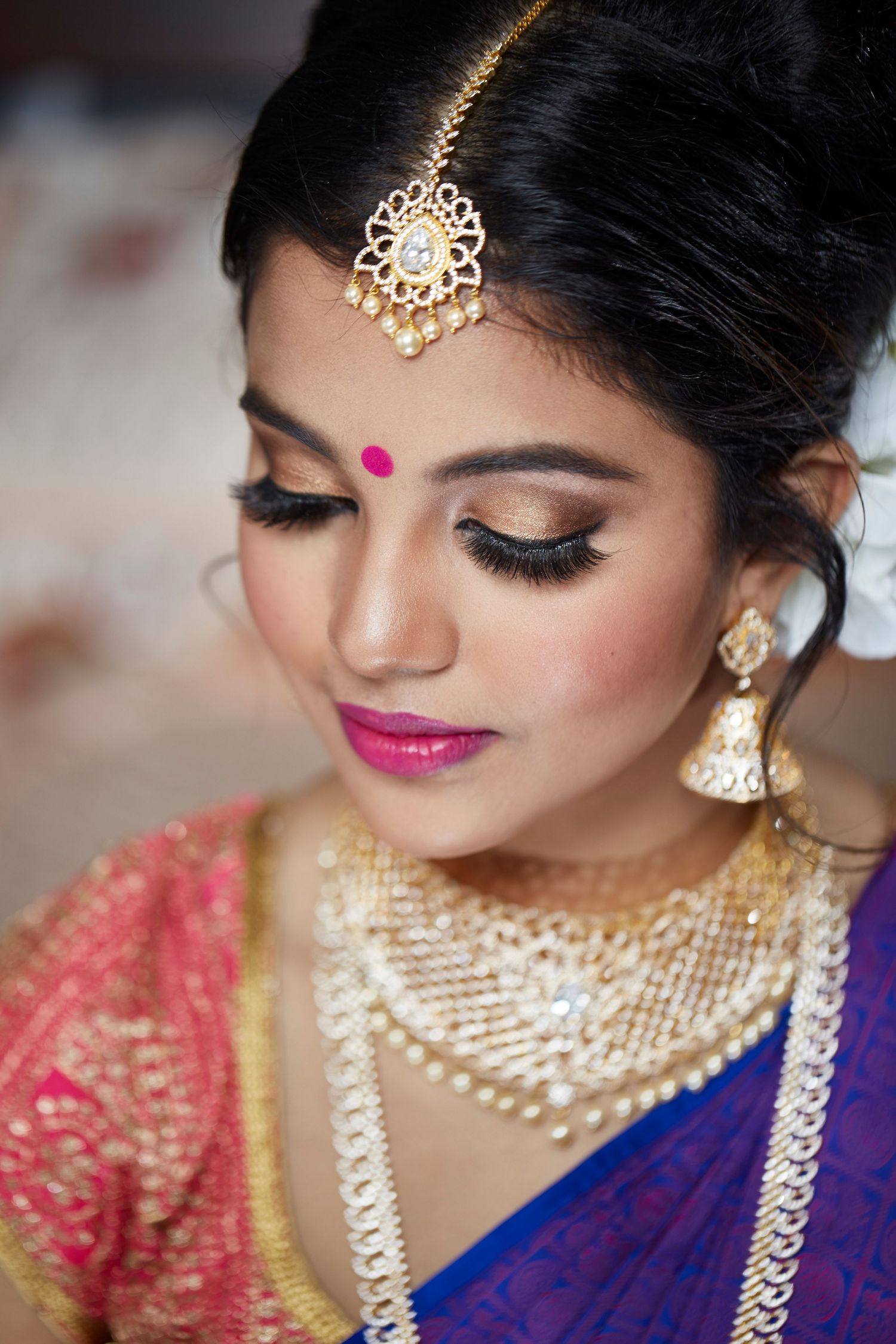 Close-up shots of intricate South Asian bridal jewelry and makeup details with bold gold accessories.