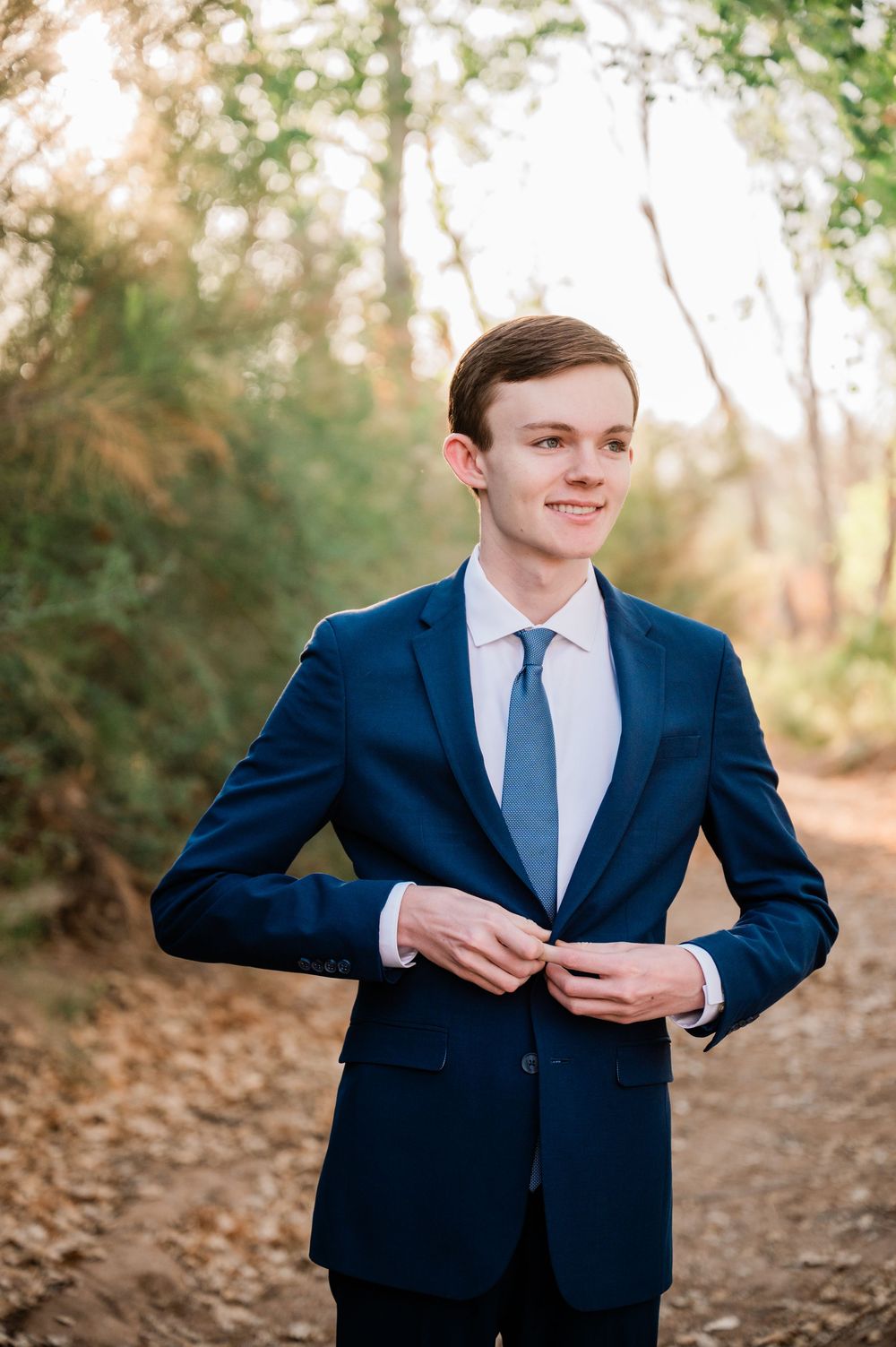 Gilbert Arizona photographer Melissa Maxwell of Jubilee Family Photography. Senior guy portraits in suit at Queen Creek Wash.