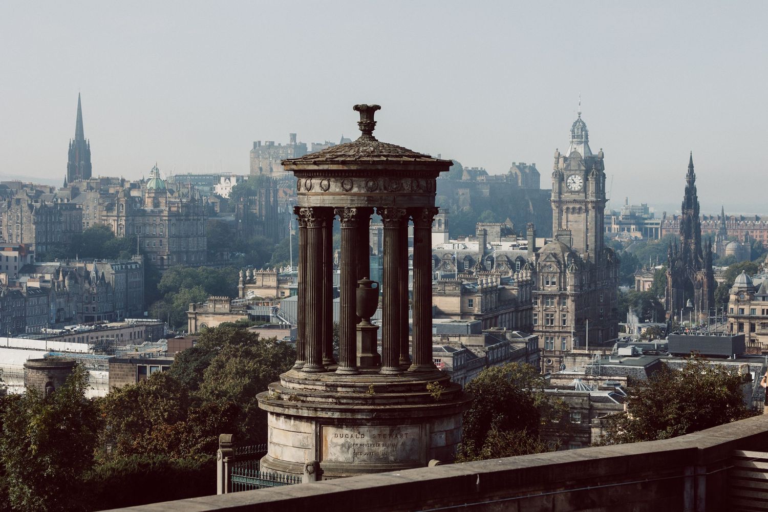 Panoramic cityscape view of Edinburgh showing historic architecture and monuments.