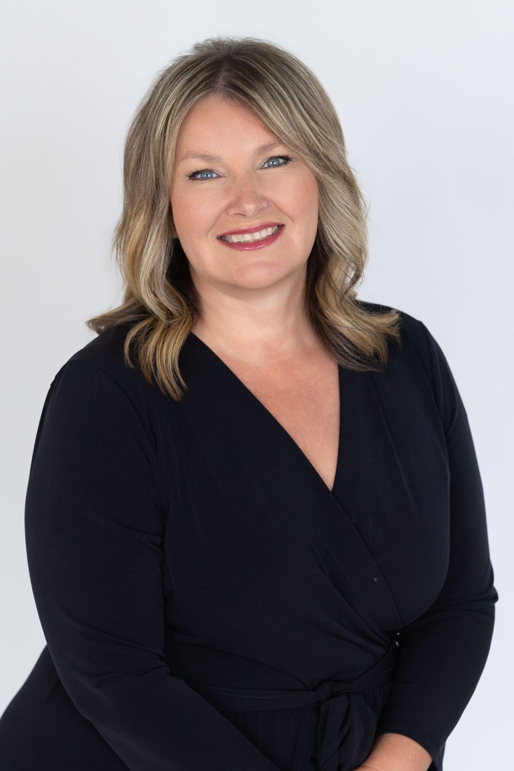 Professional studio headshot taken of a female real estate agent servicing Sioux City and Okoboji