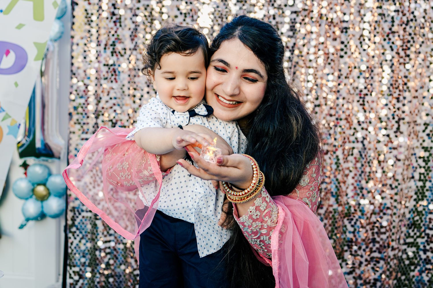 Mom and baby boy looking at a tea light candle