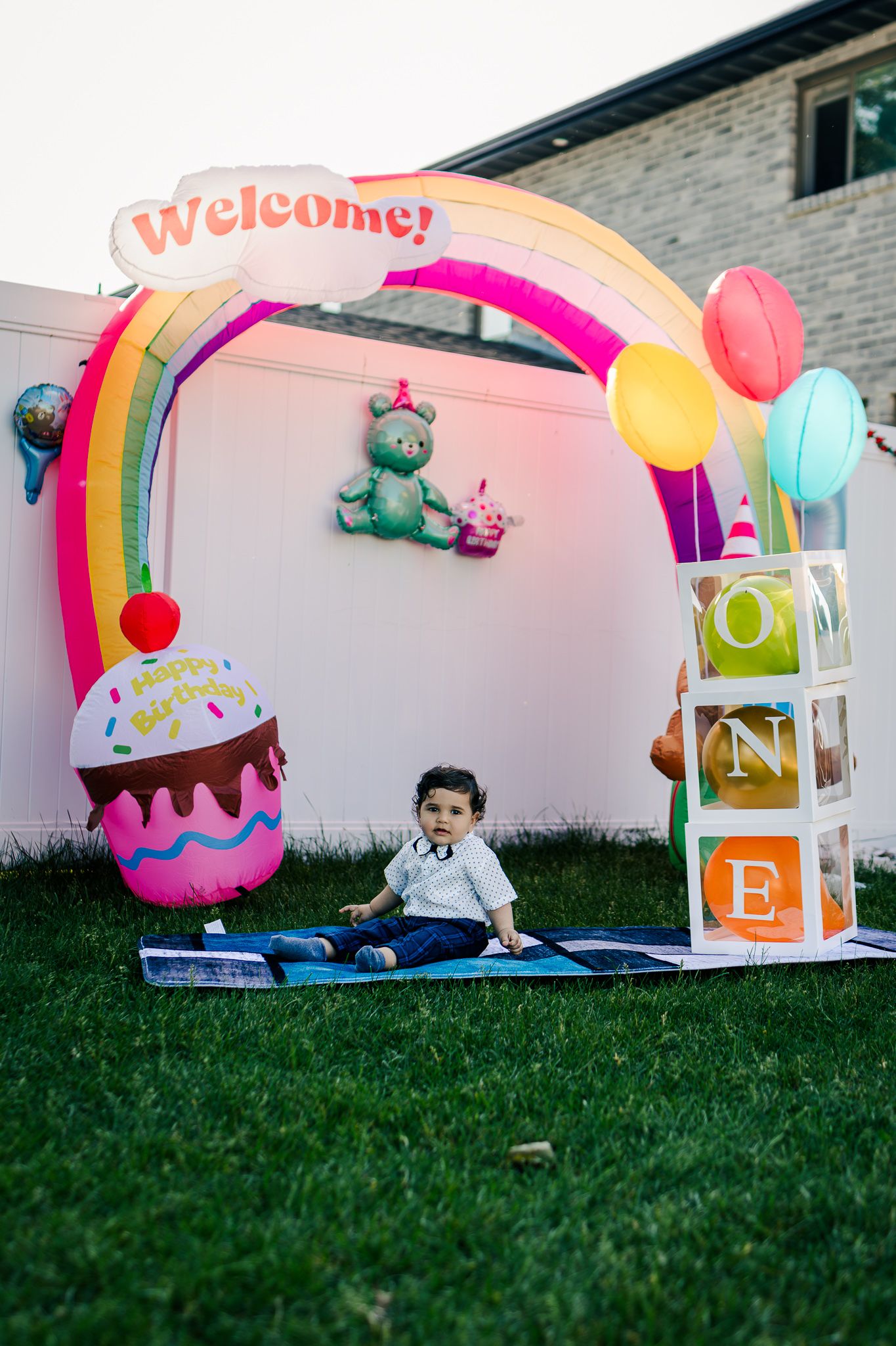 Baby surrounded by colourful balloons at his first birthday party