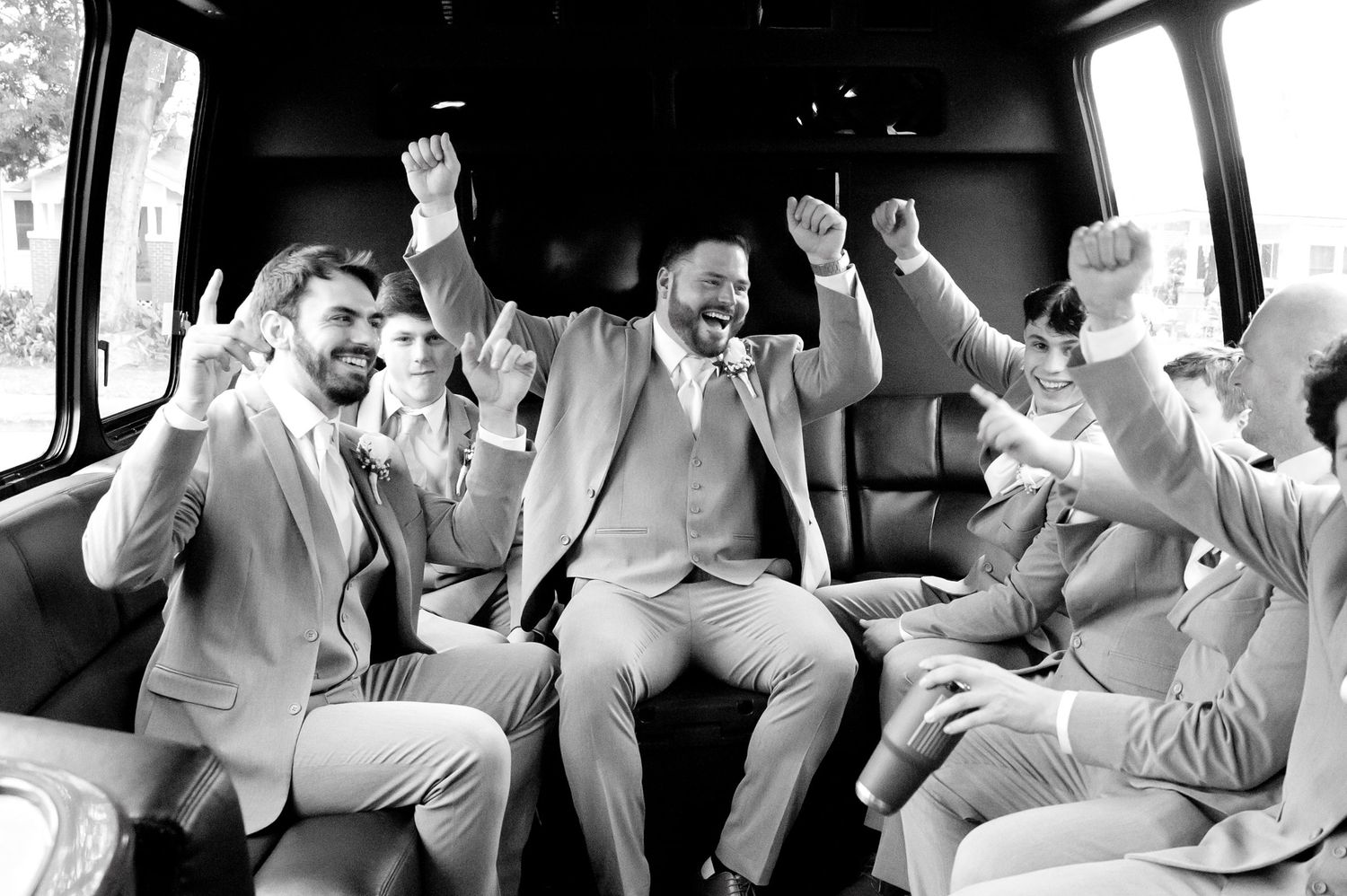 Candid celebration moments captured in black and white inside a vehicle.