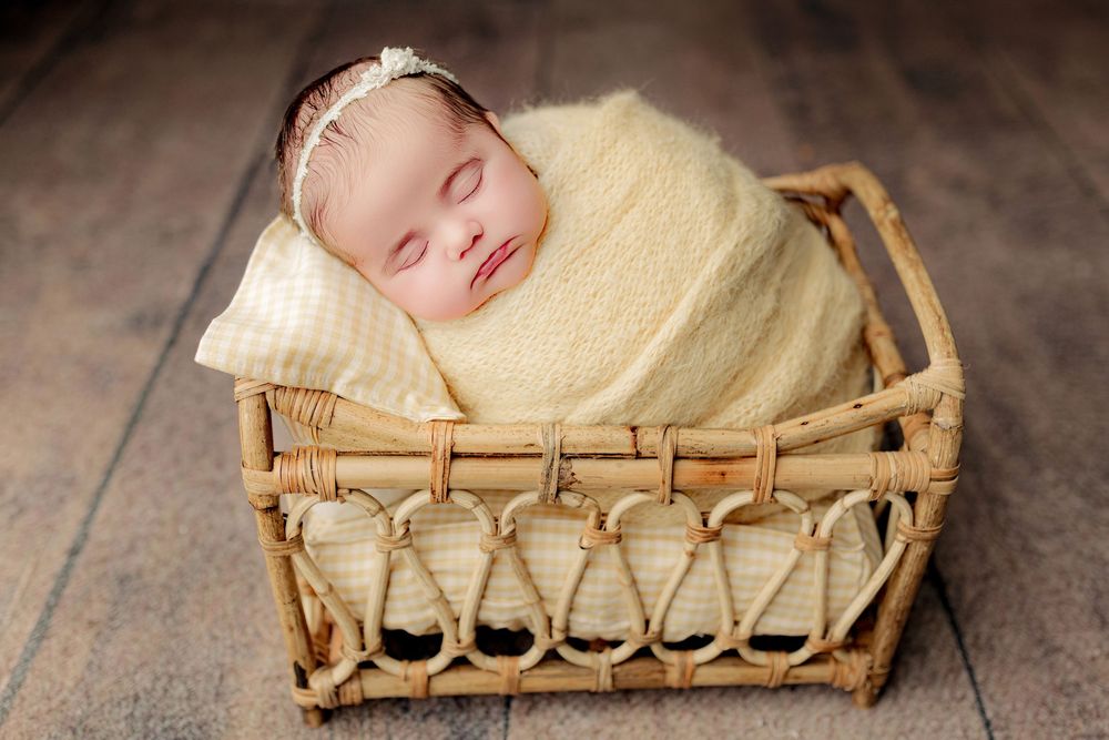 Baby girl in yellow at Tiffany Bergamino Photography's newborn studio in Marion Indiana