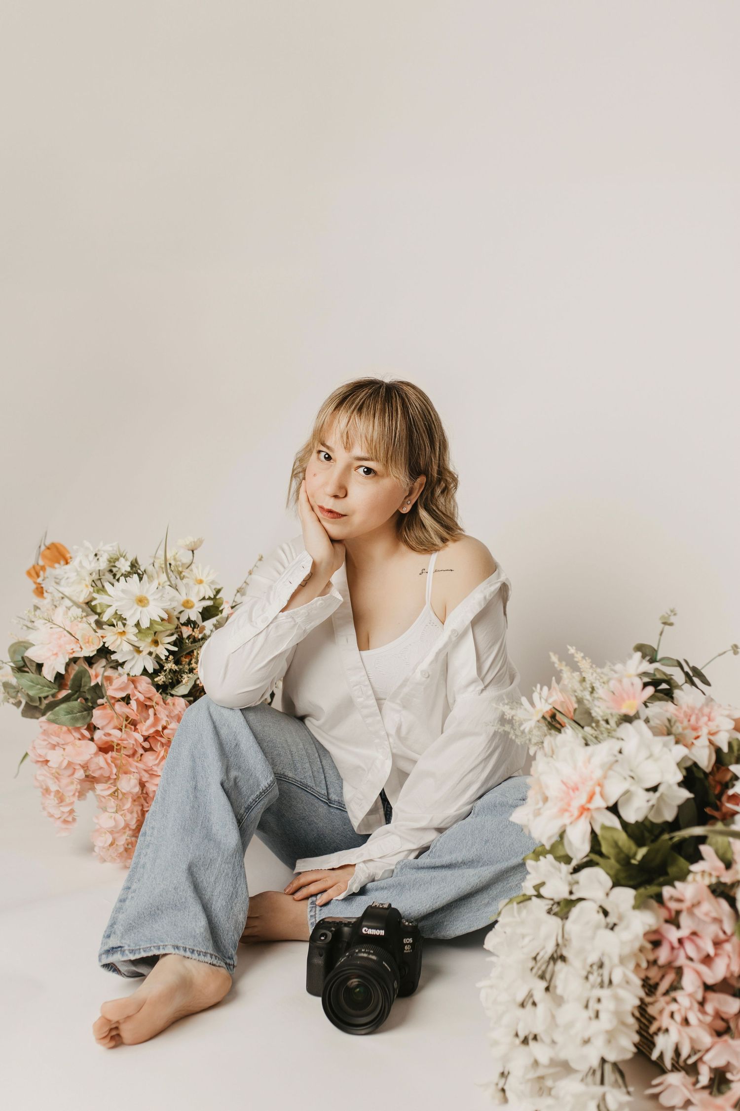 Creative portrait series of photographer with camera in bohemian studio setting.