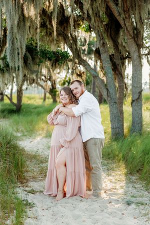 Family maternity photos under Spanish moss trees at Goose Creek State Park.