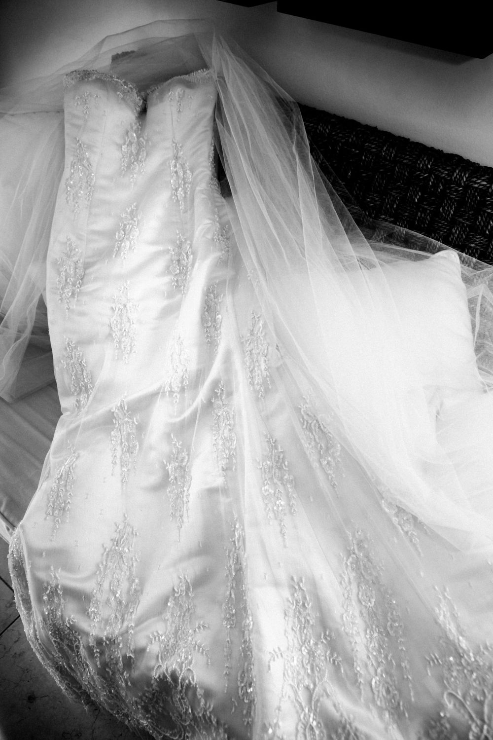 Close-up views of delicate white lace and tulle details on an ornate wedding dress shown from multiple angles.