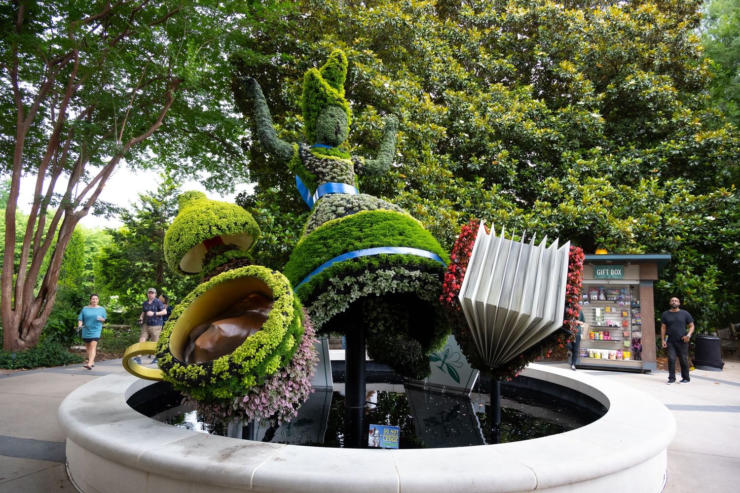 Creative garden fountain with musical instrument-shaped water features in a round basin.